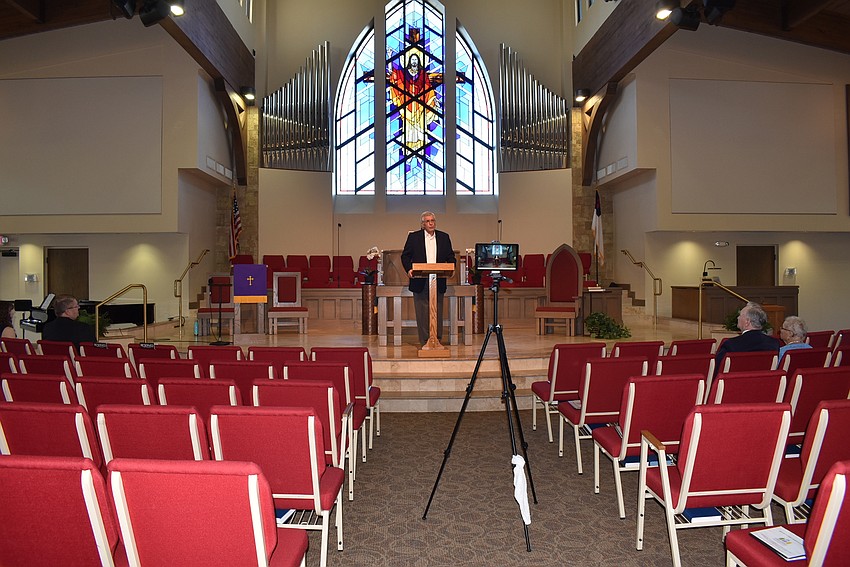 March 19: The Rev. Norman Prichard preaches to the camera and a few churchgoers at Christ Church of Longboat Key.