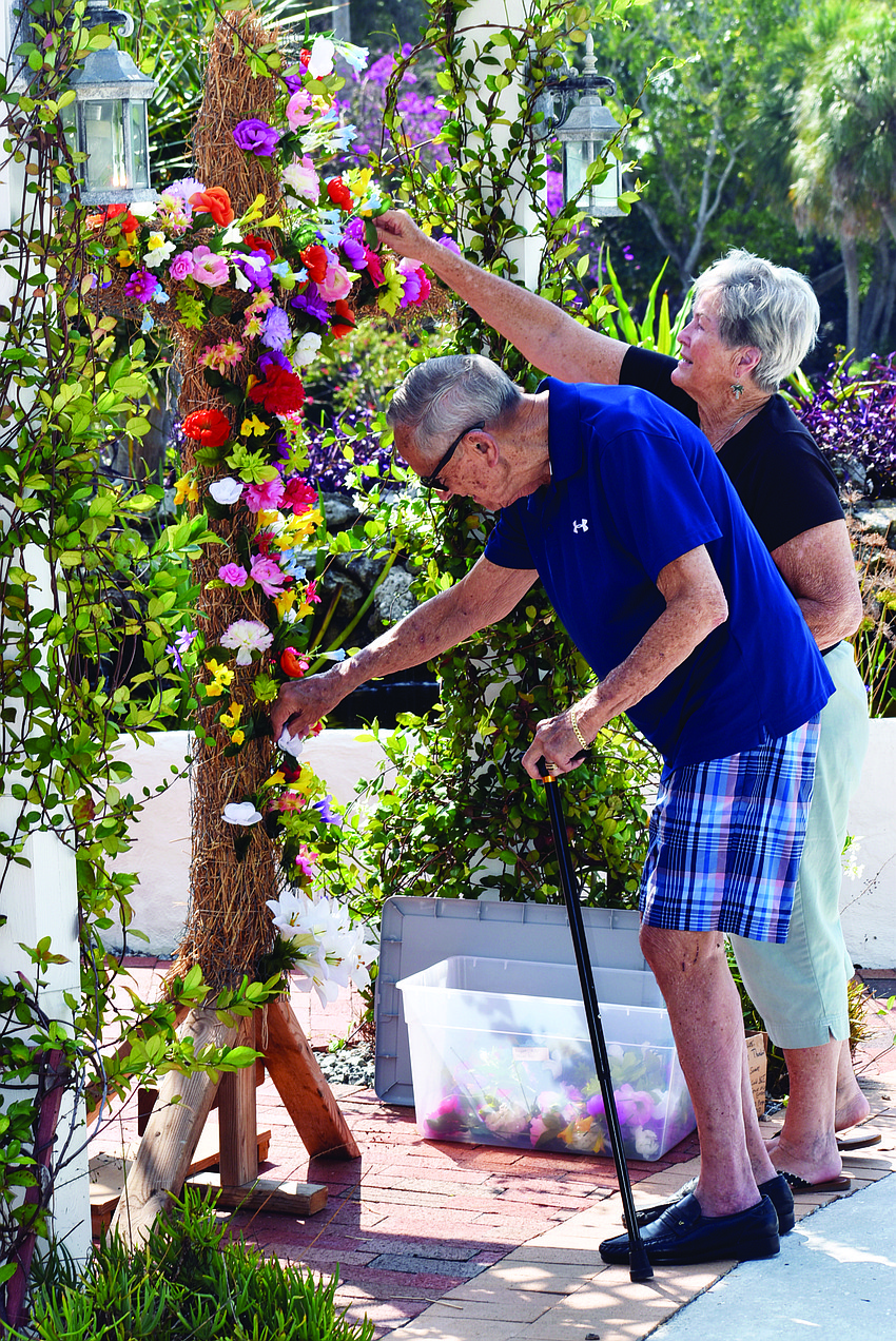 April 16: Charlie and Lois Shook add their contribution to a cross at Longboat Island chapel.