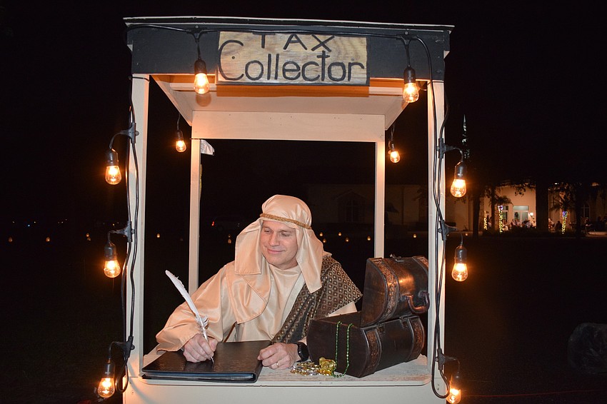 Jim Gay, a member of Evangel Baptist Church, collects taxes from people as they enter Bethlehem.
