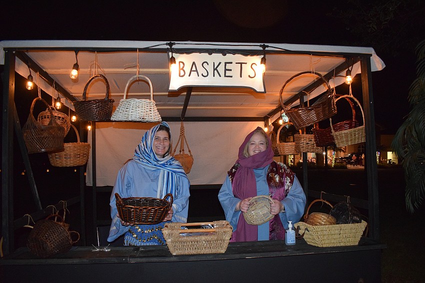 Cari Woughter and Kim Gay portray basket makers. Gay says although the drive-thru Bethlehem is different than past years, it could bring a sense of normalcy to people this holiday season.