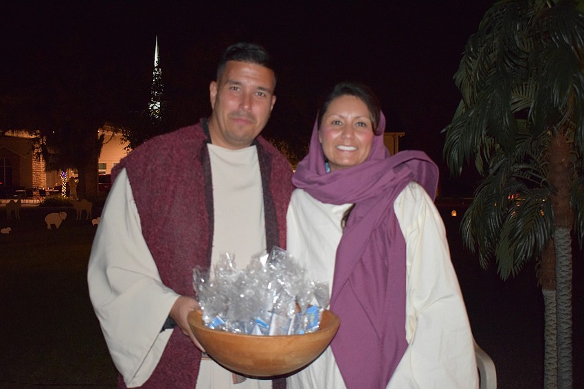 Levi and Andrea Lalond pass out pre-packaged pamphlets about the church and goodies for children. 