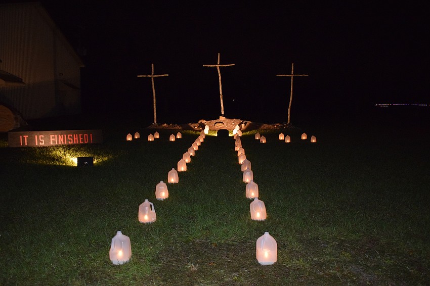 Luminaries lead up to three crosses.