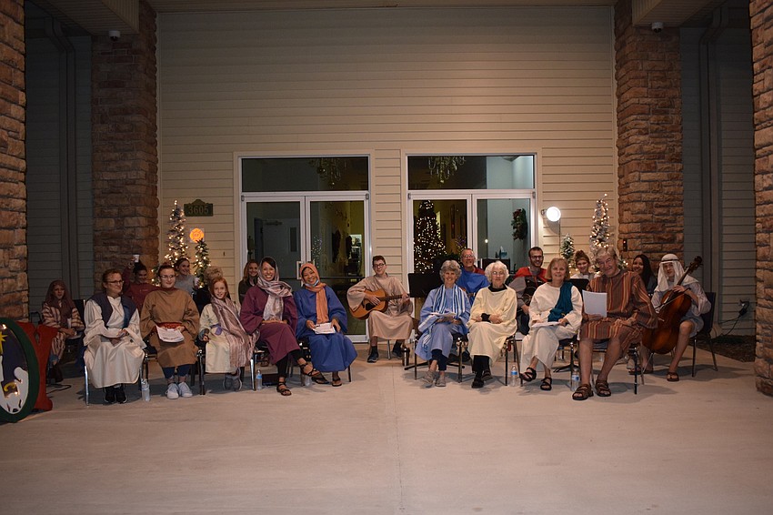 Evangel Baptist Church members sing and play instruments as people come through the drive-thru.