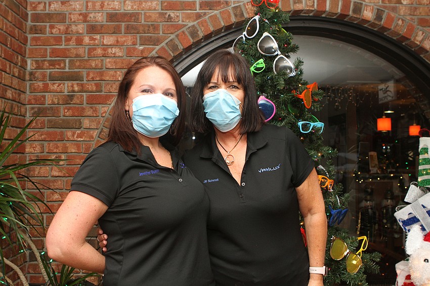 Jennifer Busch and Jill Schmidt dress up a Christmas tree at Soto Opticians on Hillview.
