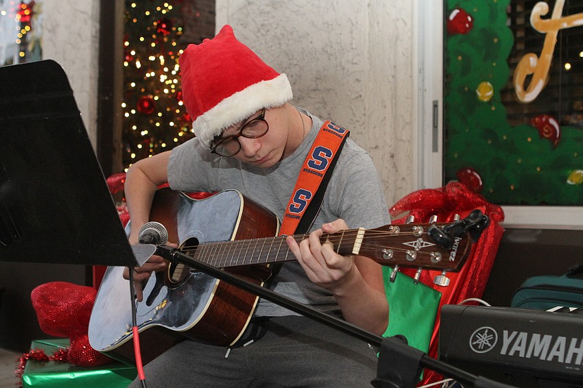 Drew Wimmer plays guitar at Gecko's.