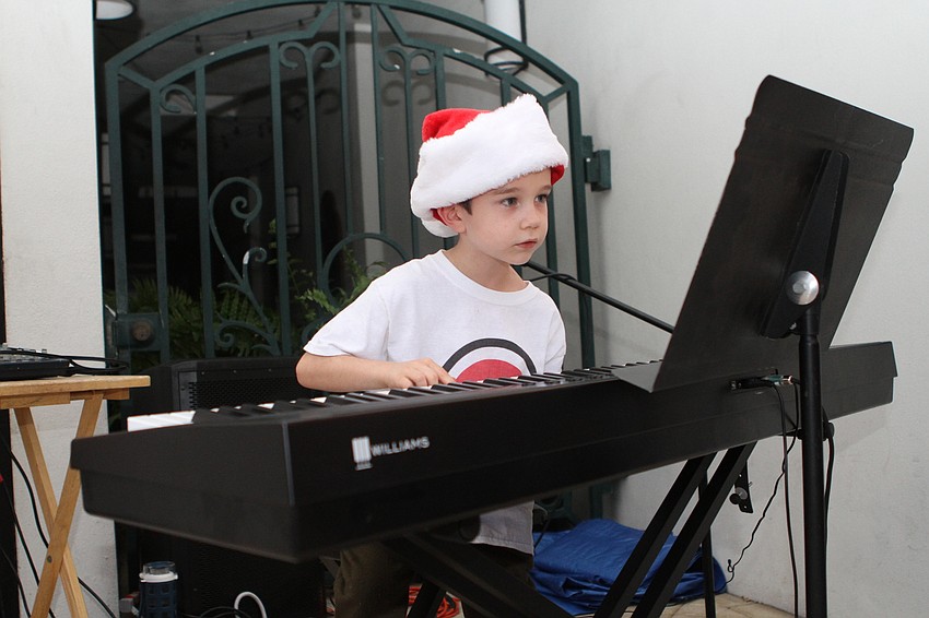 Benjamin Jennings plays piano with Music Compound outside of Knick's Tavern & Grill.