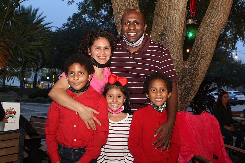 Mercedes, Dwayne, Damerious and Gicel Martin listen to DaMario play music at Gecko's.