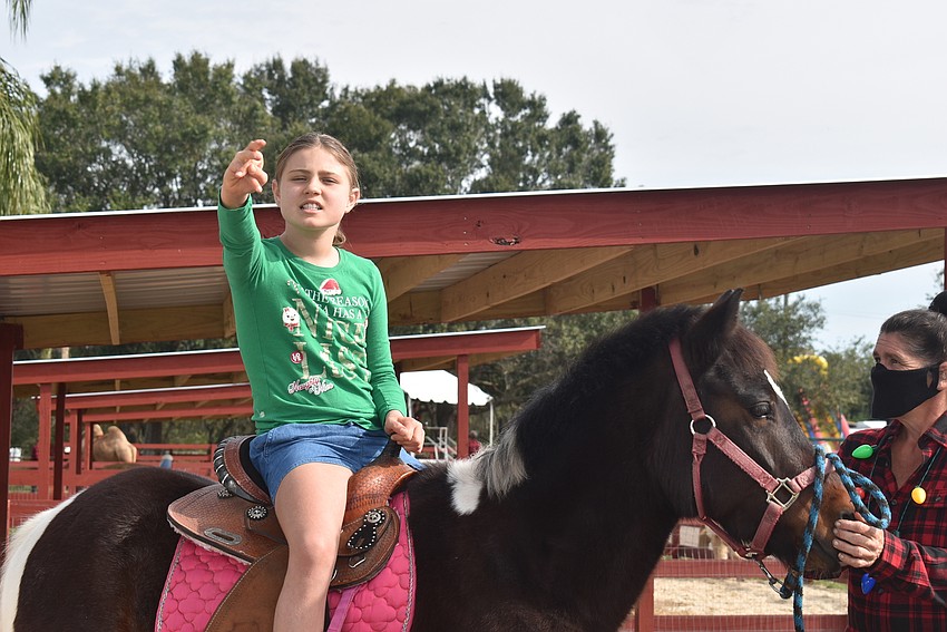 Mackenzie Laden ofSarasota rides Gorilla, a pony. Laden loves ponies and also wanted to see the giraffes.