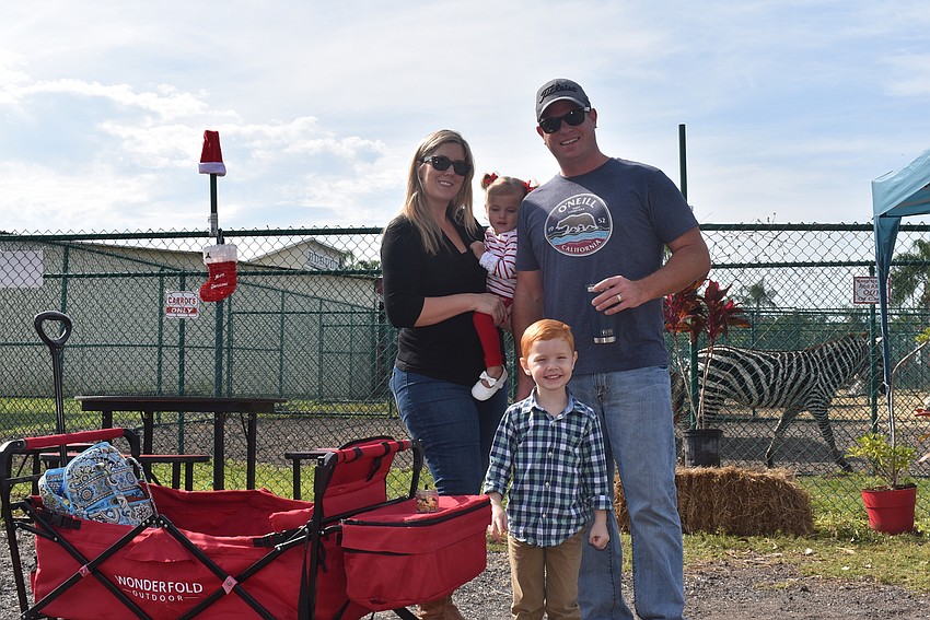 Crystal Harris (left) and Ryan Harris of Parrish and their children, Abigail and Jackson (bottom), came to see the giraffes.