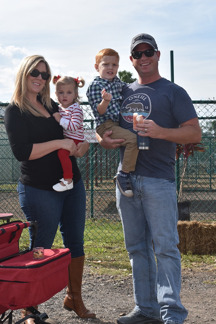 Crystal Harris (left) and Ryan Harris of Parrish and their children, Abigail (held by Crystal) and Jackson, came to see the giraffes.