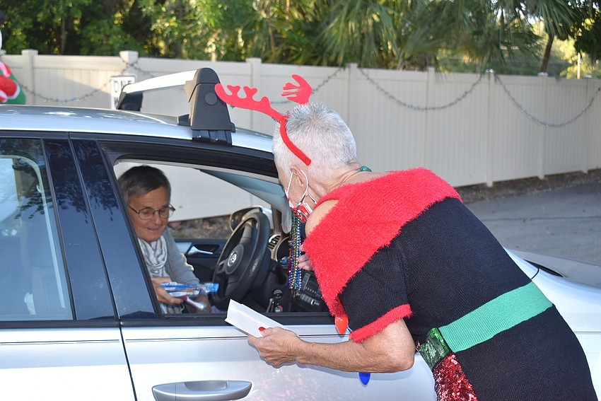 Viveca Altobelli takes a donation from Anne Marie Sopko.