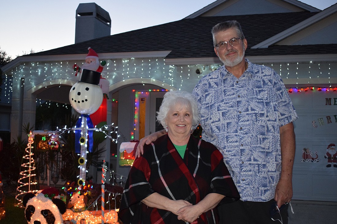 Patti Papiano says her husband, Ray Papiano, has become obsessed with adding decorations to their light display each year. They have more than 40 light-up fixtures and 50 strands of lights in their display. Photo by Liz Ramos.