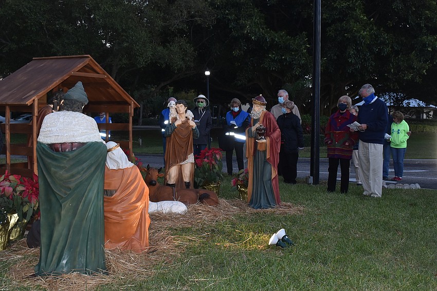 Parishioners gathered around the nativity scene and sang a few Christmas carols together.