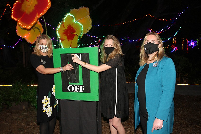 Pauline Wamsler, Schuyler Joerger and Jennifer Rominiecki flip the switch.