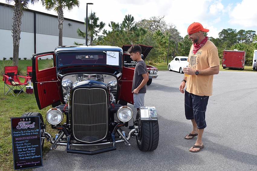 Lakewood Ranch 11-year-old Dylan Jensen and Matt Jensen, look at a 1932 Ford. 