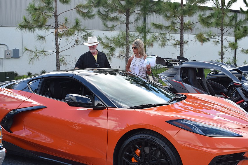Lakewood Ranch's Gary and Misty Pope look at a 2020 Corvette. The Popes, who are members of the Elks Lodge, wanted to support members who had cars in the show.