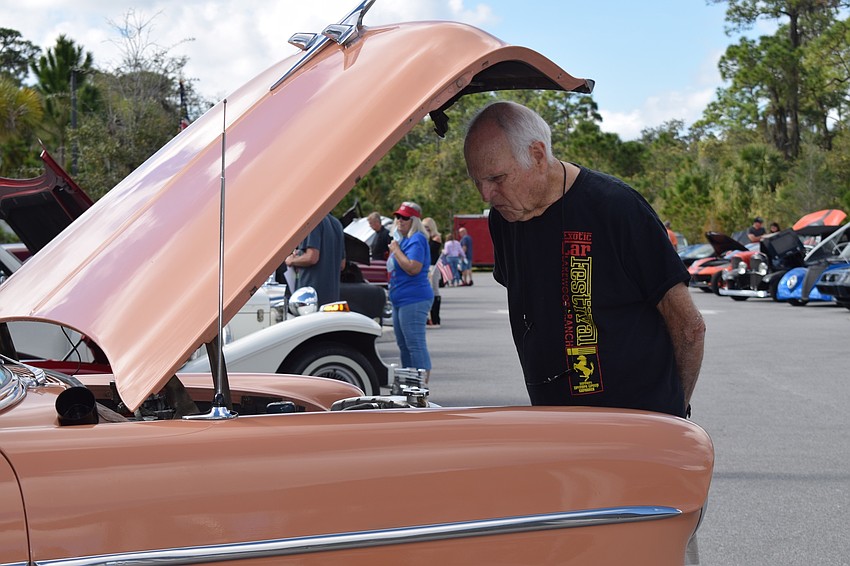 Rosedale's Bob Scott looks under the hood of a 1955 Chevrolet Bel Air. 