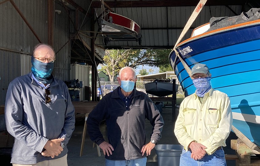 Dec. 12: Chad Weiss, John Pether and Pat Ball inside the former studio of wood-boat builder George Luzier.