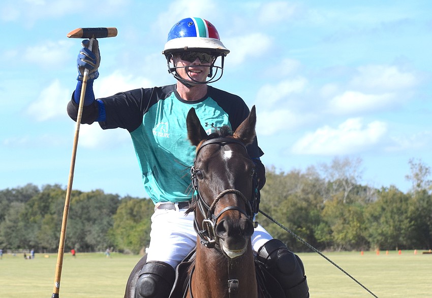 Epic Equine's Stuart Campbell salutes the crowd before the match.