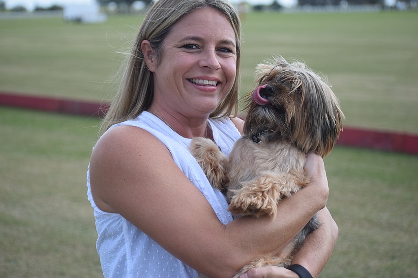 Rebecca Marsters gives Misiu the Yorkie a hug before the start of the polo match. Sarasota Polo Club is dog friendly.
