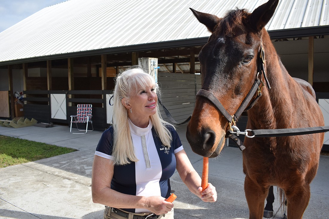 Robin Ruhnke says the Sheriff&#39;s Office retired horses will have green grass â€” and carrots as Valor enjoys â€” forever in her fields.