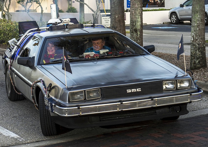 Dr. Larry and Pat Thompson arrive as “Captain Creative and The Imaginator” in a 1982 DeLorean