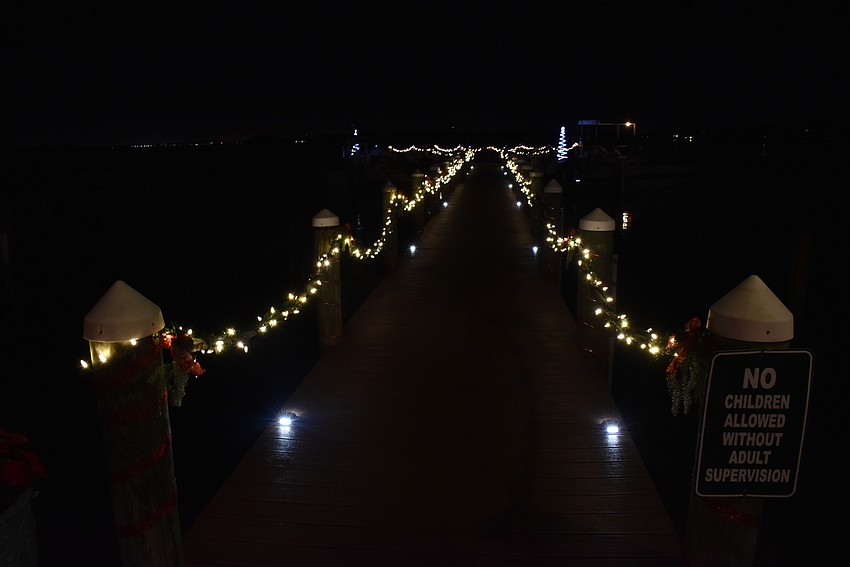 The dockway is lit with garlands.