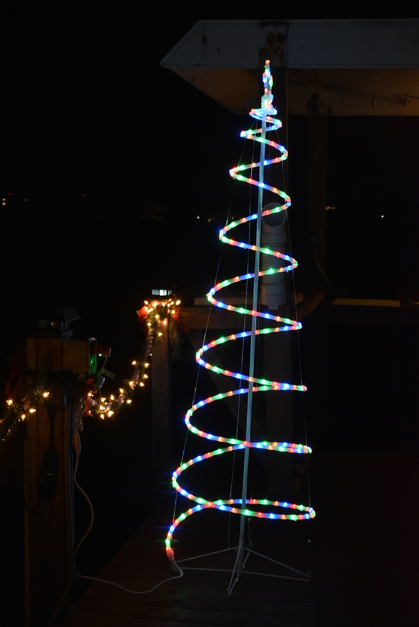 Spiraling, multicolored trees frame the two sides of the dock.