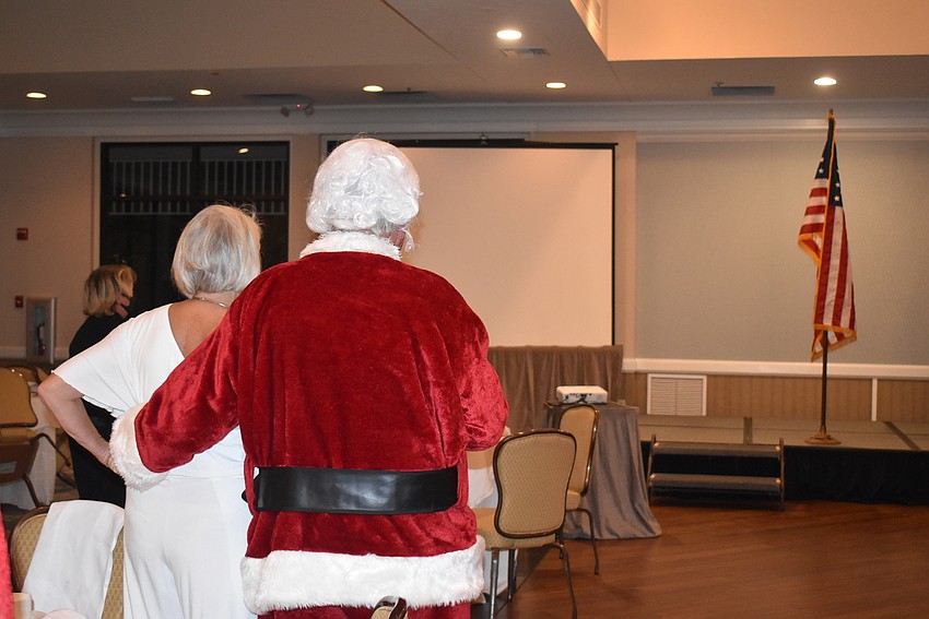 Jane Hunter and John Wheeland rise for the invocation.