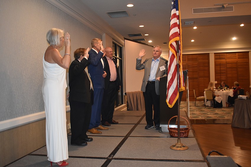Jane Hunter, Bob Parish, Chris Sachs and Scott Gray are sworn in by Jack Brill.