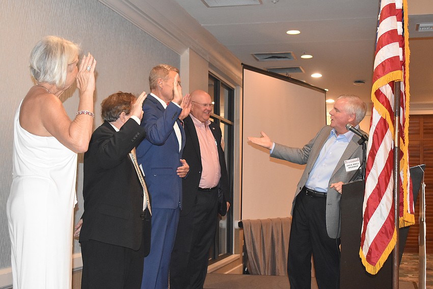 Jack Brill, right, congratulates the new board of Jane Hunter, Bob Parish, Chris Sachs and Scott Gray on their accomplishment.