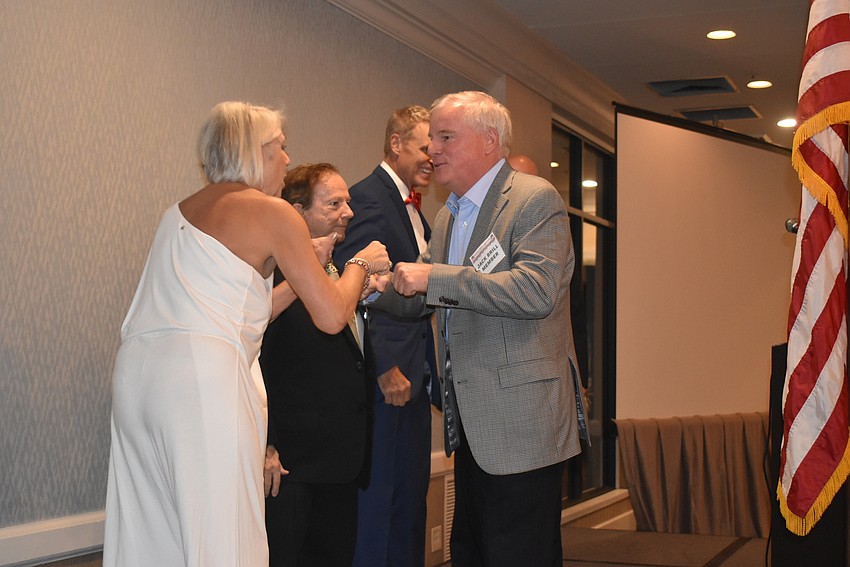 Jack Brill, right, congratulates the new board of Jane Hunter, Bob Parish, Chris Sachs and Scott Gray on their accomplishment.