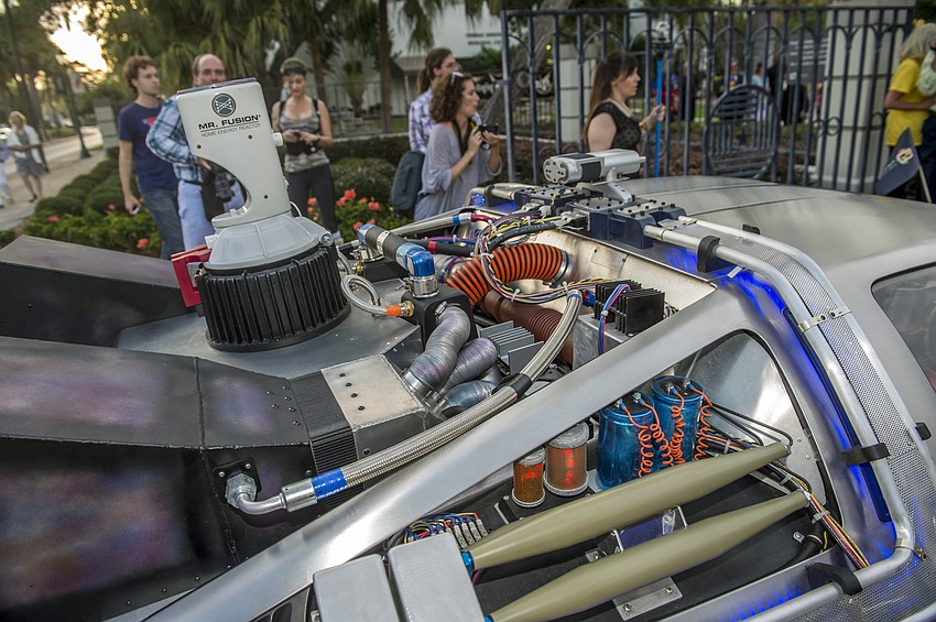 Dr. Larry and Pat Thompson arrive as “Captain Creative and The Imaginator” in a 1982 DeLorean