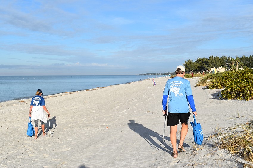 Nancy and Jack Rozance spread out to make sure they hit the whole swath of sand.