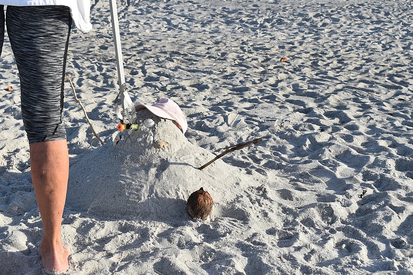 A sand-man had a diving toy for a nose. Because it could look like a tasty snack for a marine animal, Nancy Rozance removed it.