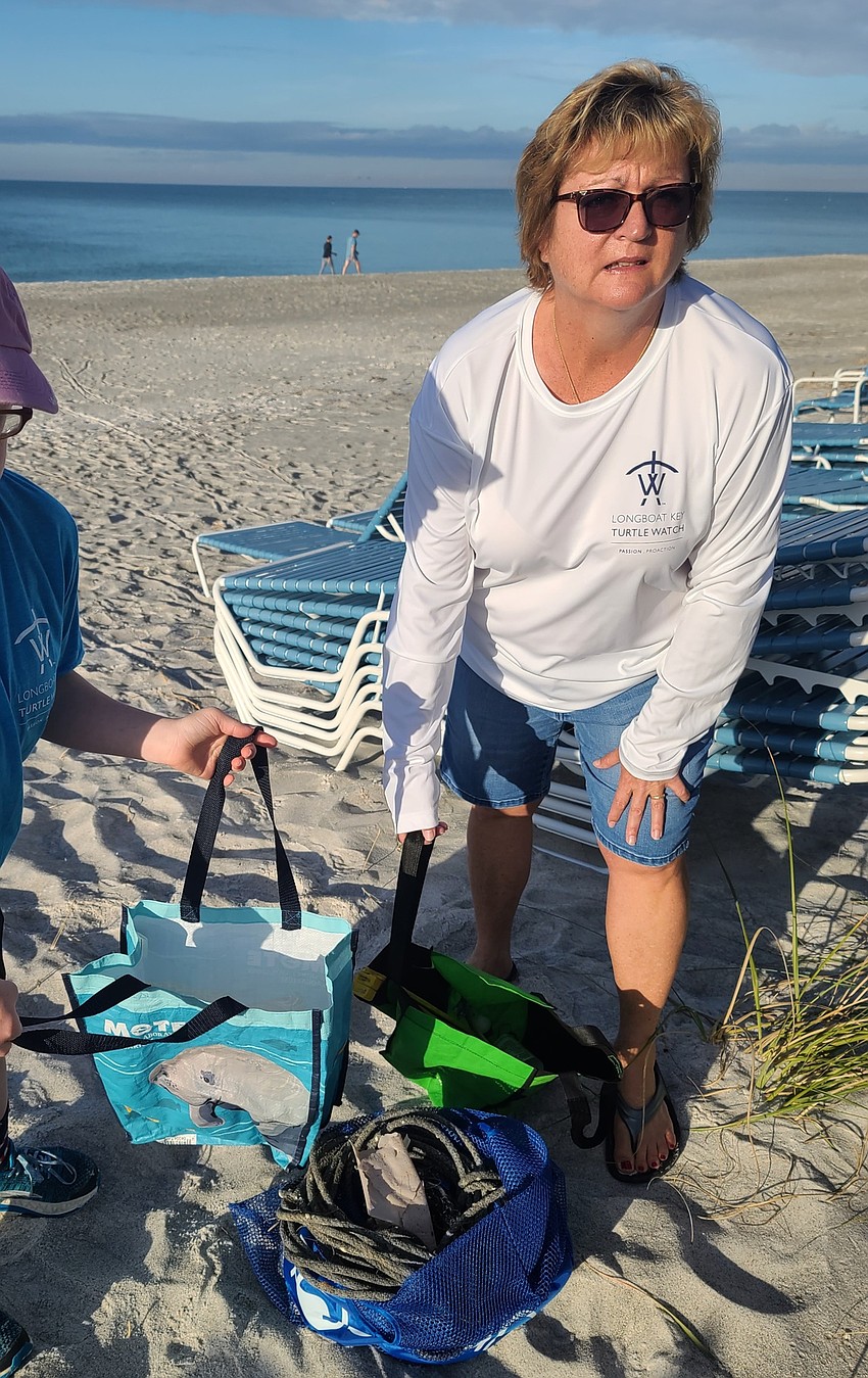 Organizer Dawn DiFoggio stands with the trash collected in just 15 minutes. Courtesy photo.