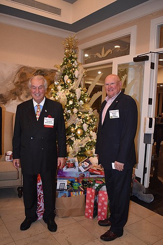 Joe McElmeel and Scott Gray stand in front of gifts donated by the Republican Club of Longboat Key.