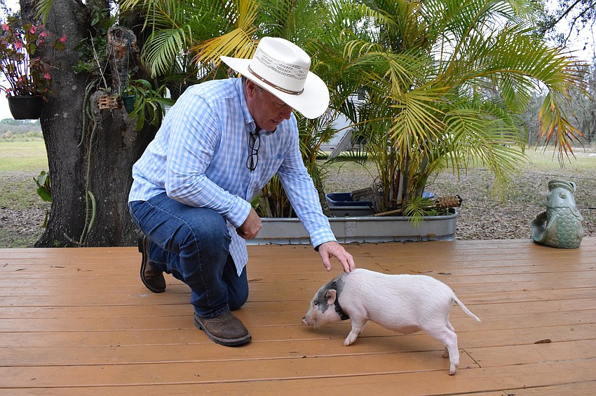 Les Kimes pets Sparky. Kimes says he spends time with the animals and takes good care of them to show them he respects them.