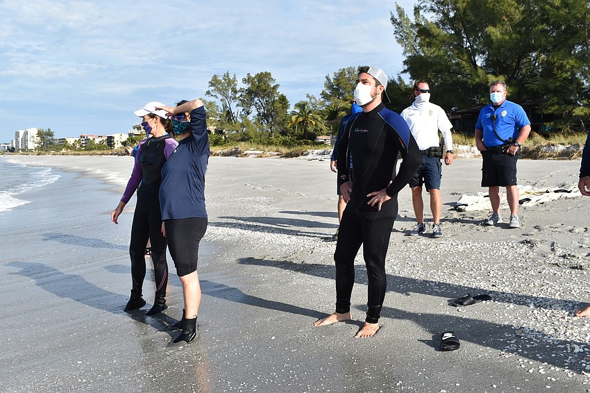 Crews look at the Gulf of Mexico after the release of the loggerhead sea turtle.