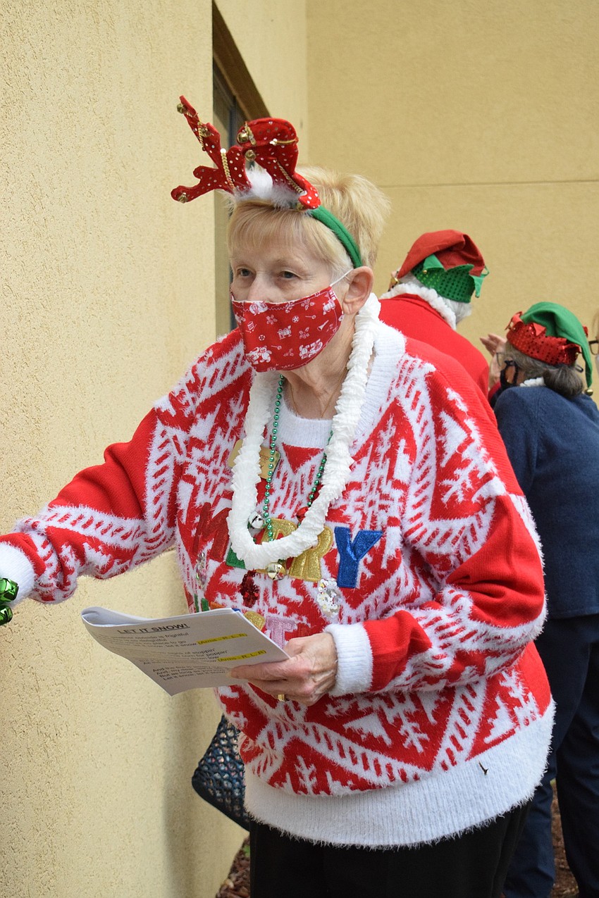 Dressed in festive gear, Dorothy Klodnicki sings 