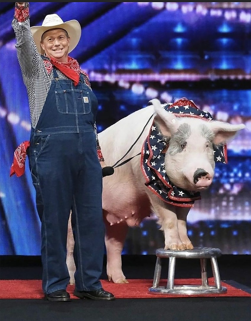 Les Kimes stands beside Mac while waving to the 