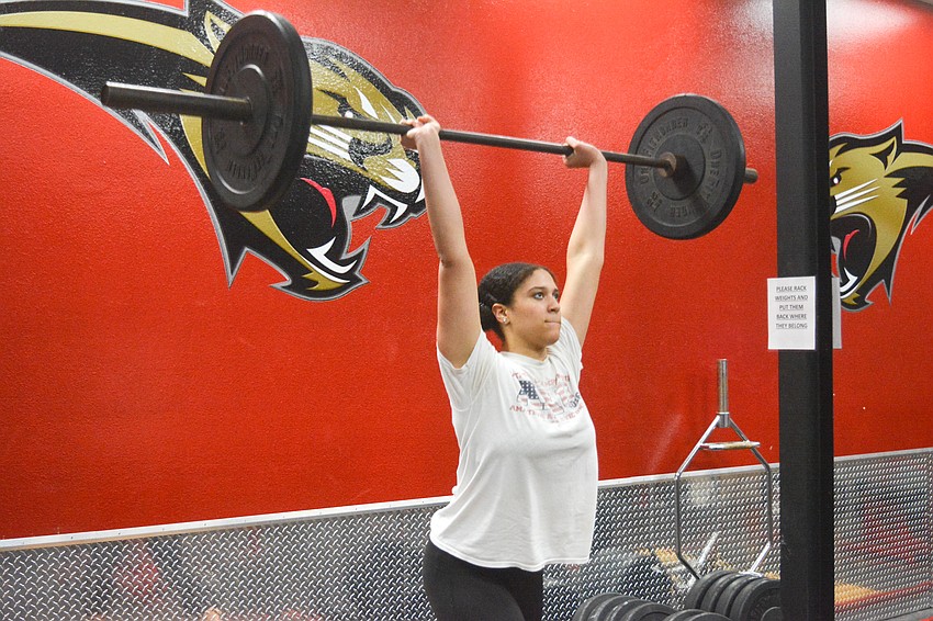 Cardinal Mooney High then-junior Adrienne Boynes practices her clean-and-jerk skills at weightlifting practice. Boynes won the 199-pound division of the school's regional meet Feb. 2, bench pressing 125 pounds.