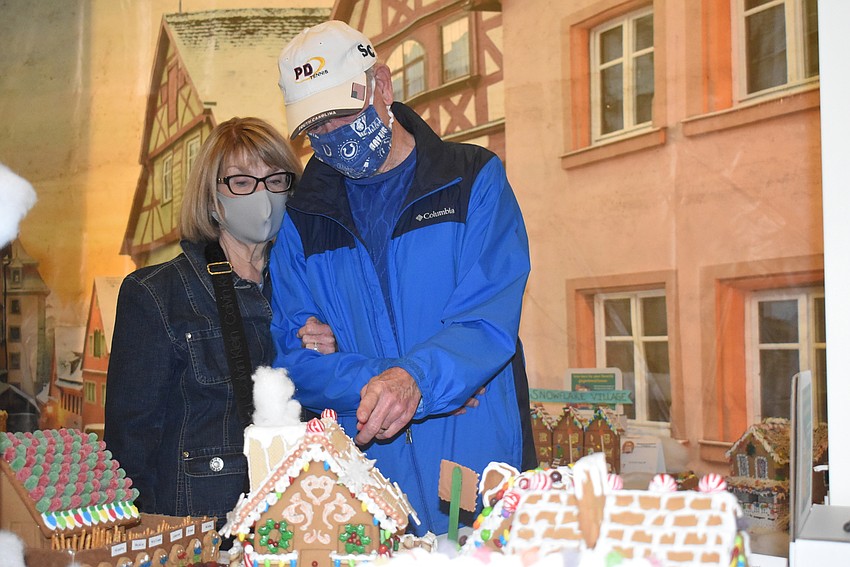 Melinda and Bill Nieman of Sarasota look at the gingerbread house created by Mrs. Davis' third grade class at the Suncoast School for Innovative Studies.