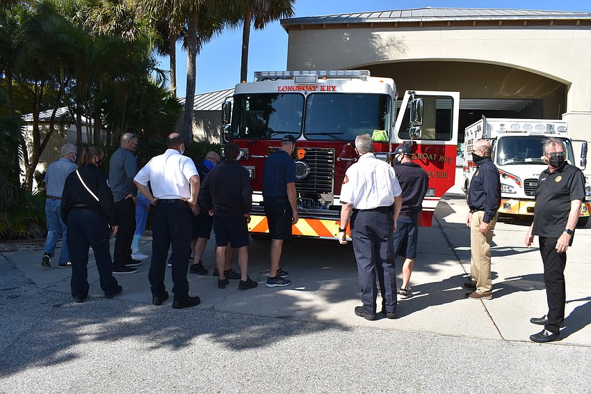 Longboat Key Fire Rescue personnel and town staff push the new fire truck into the bay at 5490 Gulf of Mexico Drive.