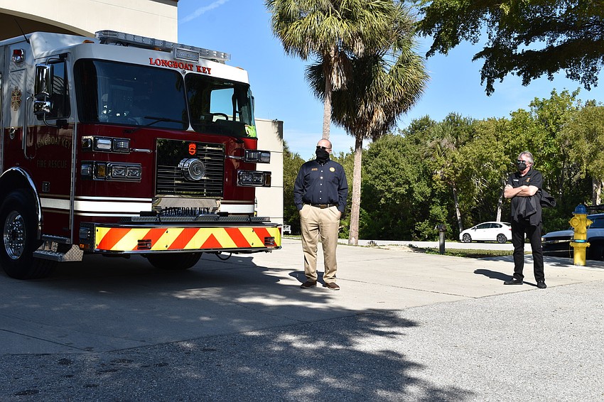 Town Manager Tom Harmer (left) and Vice Mayor Mike Haycock (right) look on during Monday afternoon's fire truck dedication ceremony.