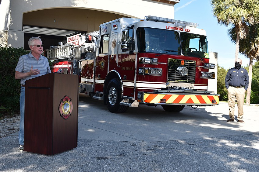 Longboat Key Mayor Ken Schneier spoke during Monday afternoon's fire truck dedication ceremony as Town Manager Tom Harmer looks on.