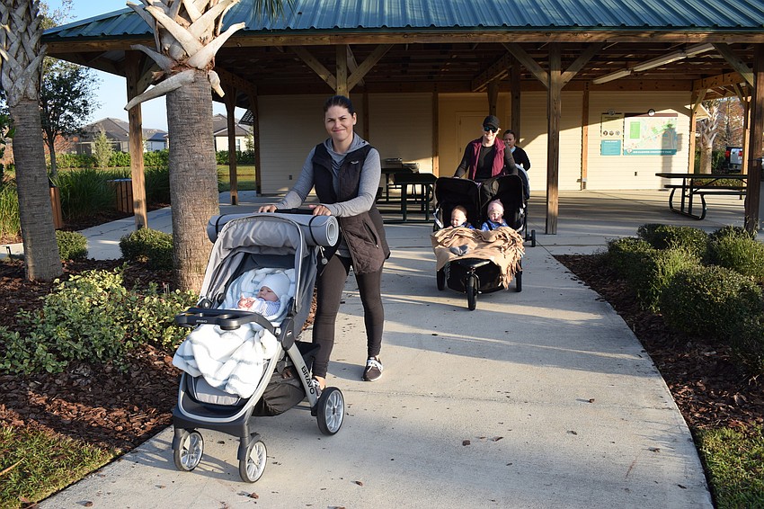 Victoria Korotkova and RaeAnna Kalkert take off on the pathway with their children Ian Korotkov and Dakota Kalkert and Hudson Kalkert in their strollers.