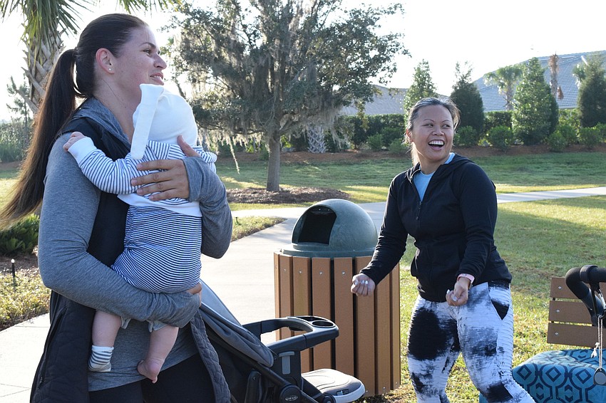 Arbor Grande's Victoria Korotkova modifies her workout from fitness instructor, Marie Tabuena-Urriola, so she can care for her 3-month-old son Ian Korotkov.