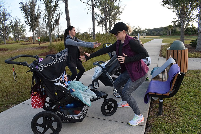 Arbor Grande's Victoria Korotkova and Esplanade's RaeAnna Kalkert go through exercises in front of their children.