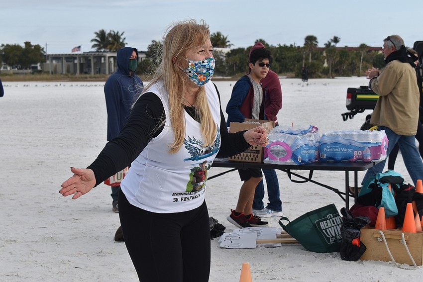 Stacey Monroe waves finishers into the chute.